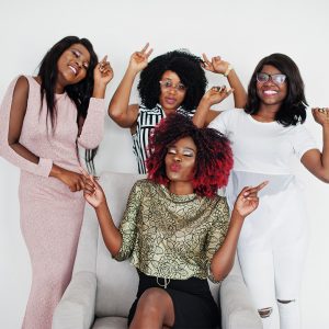 Four stylish African American women celebrating success